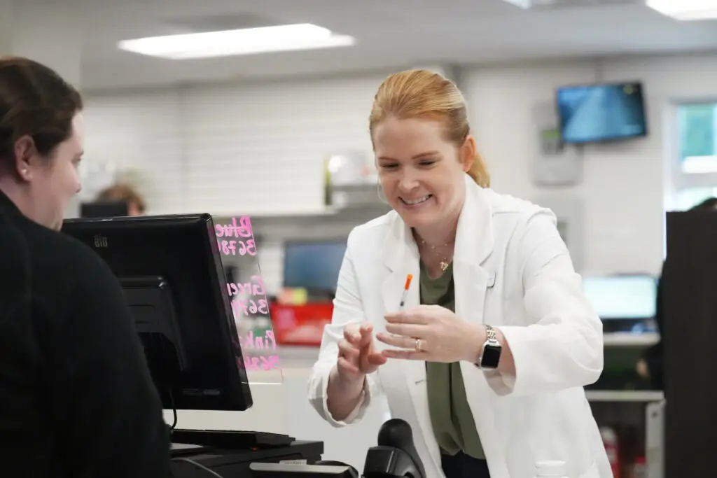 Westmoreland front desk communicating with patient about injection image